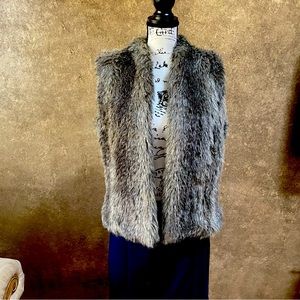 Faux fur fashionable vest.  Perfect over turtleneck and paired with tall boots